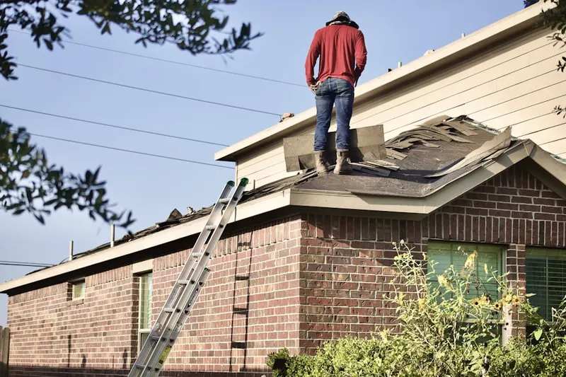 Professional roofer working on a residential roof in Rosini